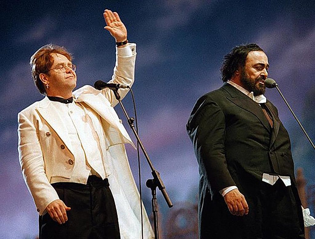 The English singer, songwriter, and pianist, Elton John, with the Italian tenor Lucian Pavarottin during the "Pavarotti & Friends" concert in the Italian city of Modena in 1996.